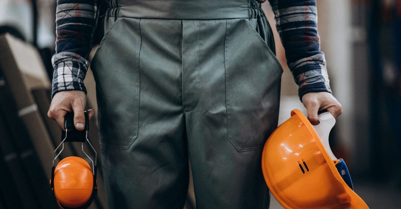 young-male-handyman-with-safety-earphones young-male-handyman-with-safety-earphones